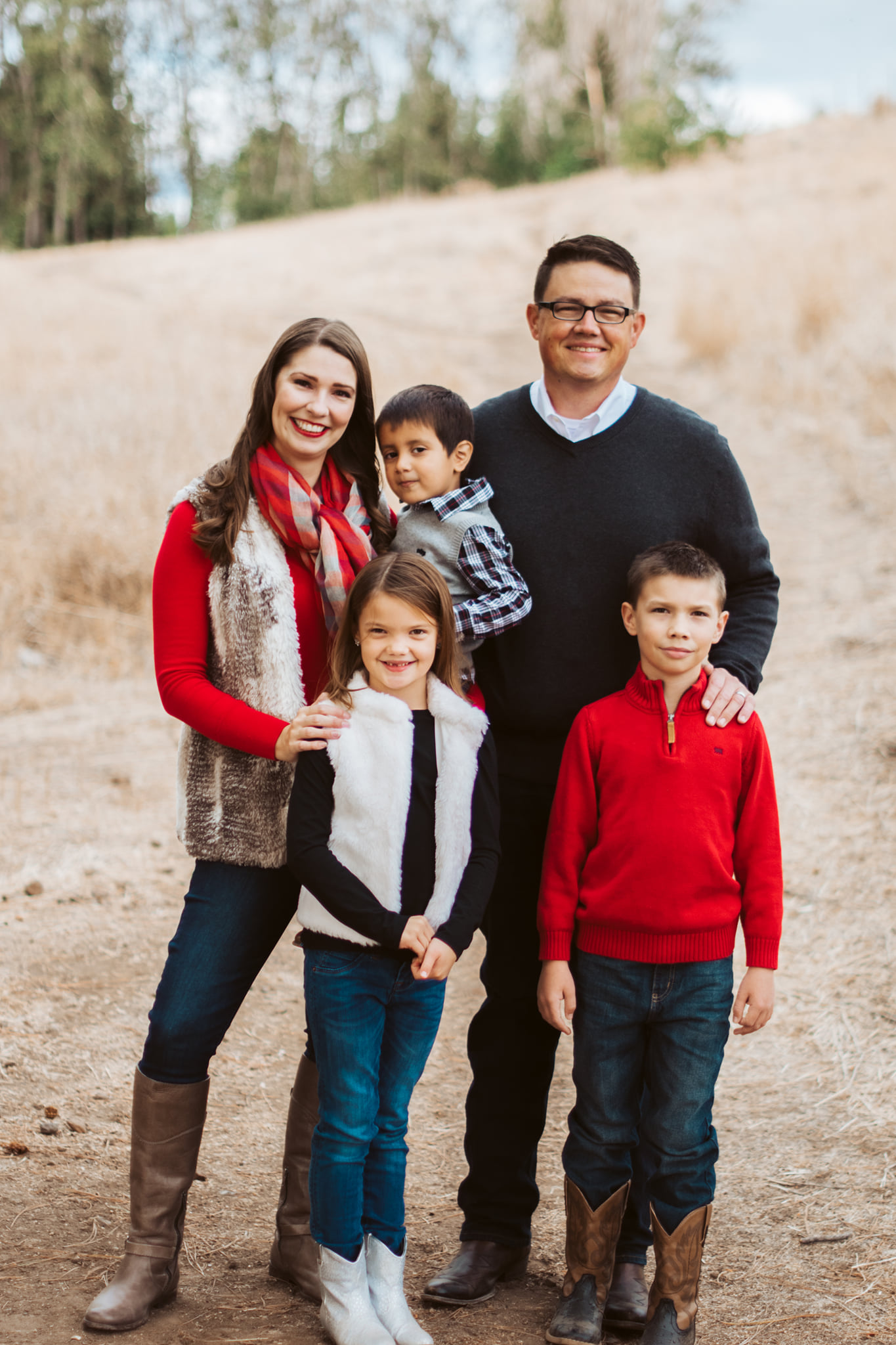 Chris Corry and his family standing in dry grass