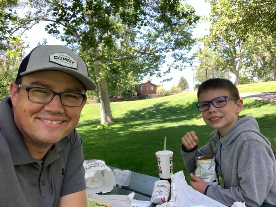 Chris having lunch at the park with one of his sons