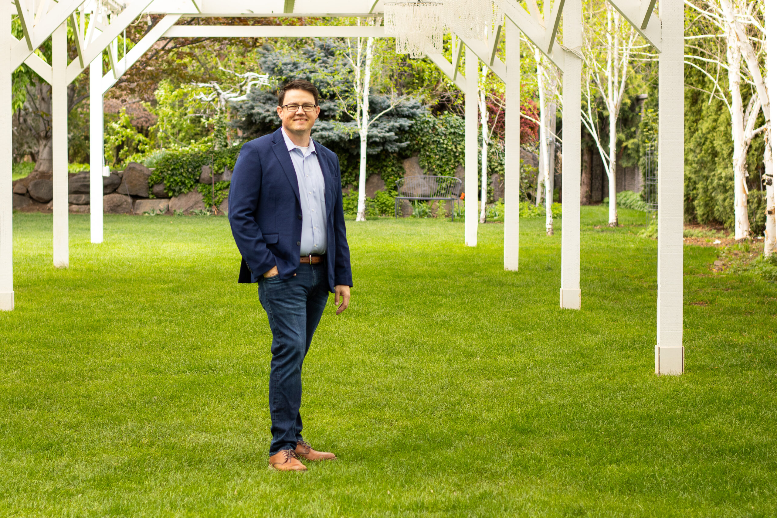 Chris Corry standing in tall grass for a portrait